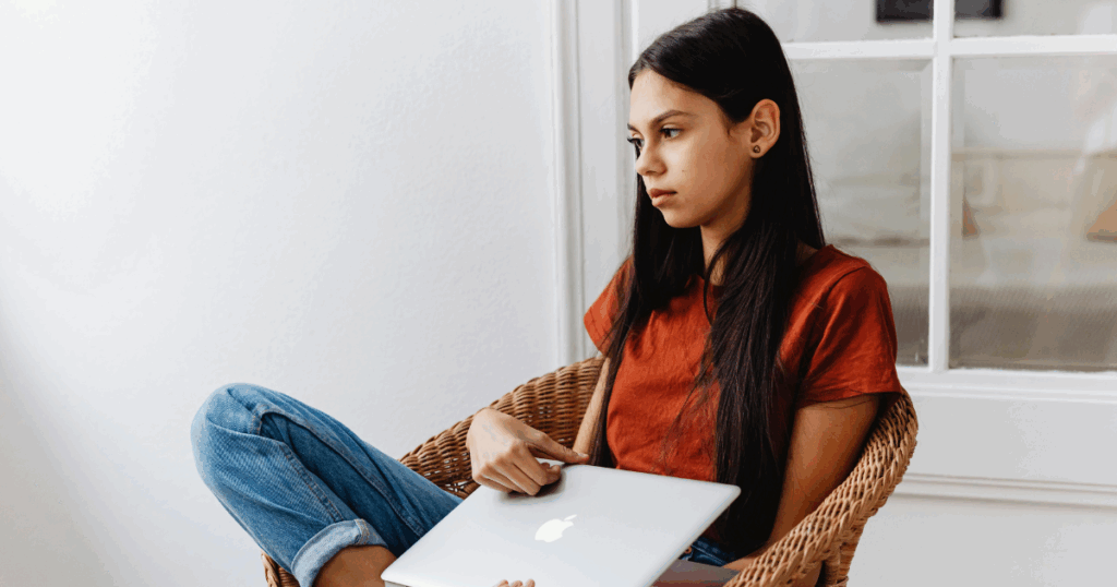 image - My Teen Mental Health Teenage girl looking thoughtful with a laptop. Warning signs of teenage suicide, risk factors, and how to help concept.
