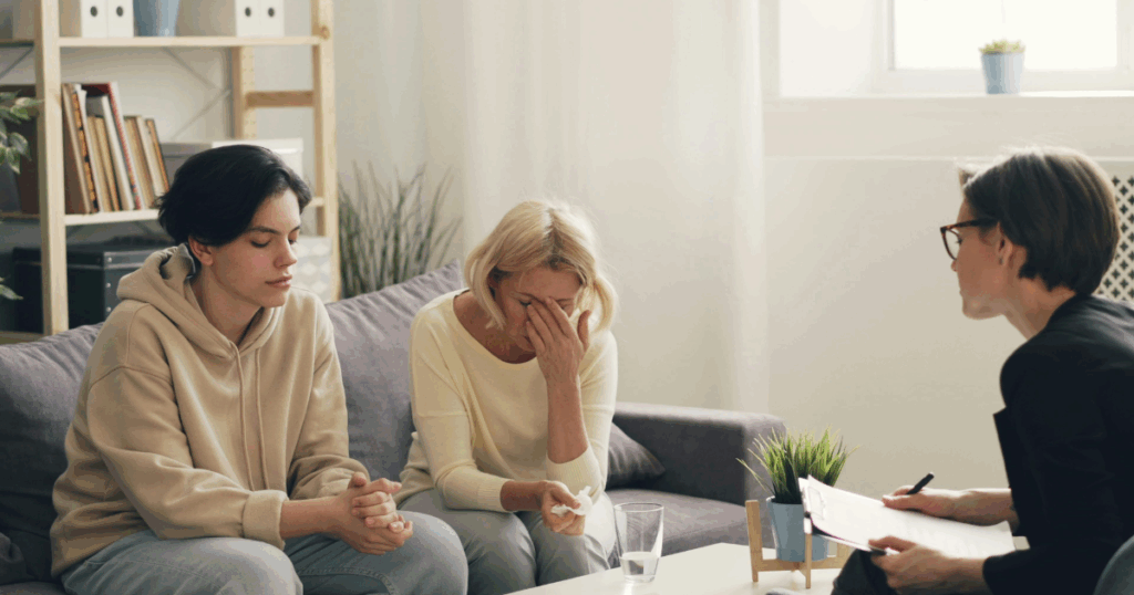 image - My Teen Mental Health Teen therapy session showing trust and communication: mother crying, teen and therapist present. Mental health support.